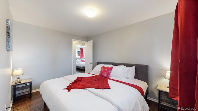 bedroom with dark wood-type flooring