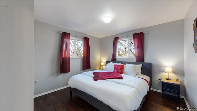 bedroom with dark hardwood / wood-style floors