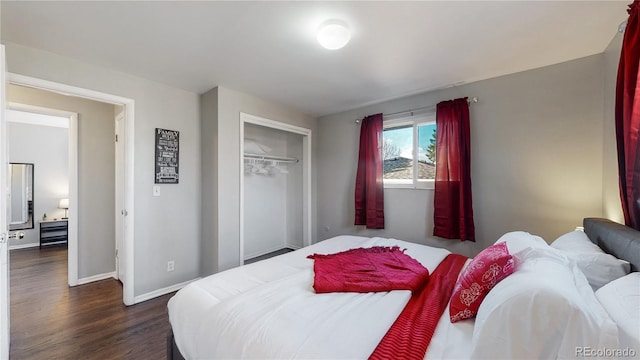 bedroom with dark wood-type flooring and a closet