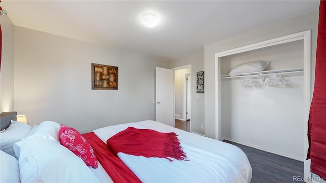 bedroom featuring a closet and dark hardwood / wood-style floors