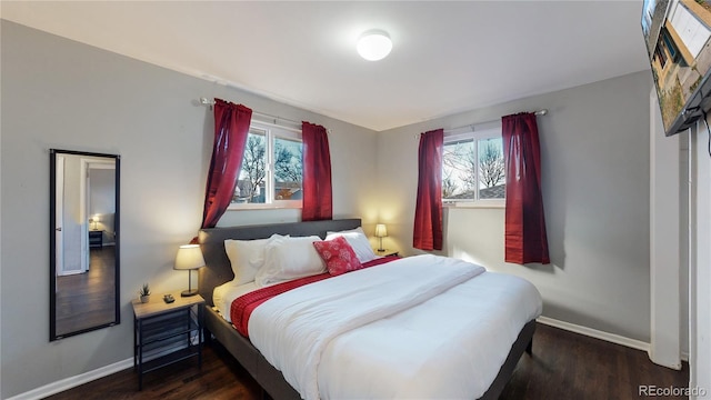 bedroom with dark wood-type flooring