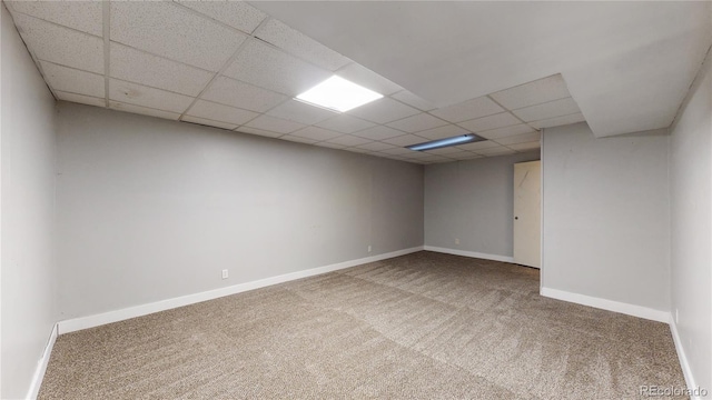 empty room featuring carpet floors and a paneled ceiling