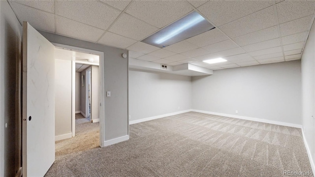 basement with carpet and a drop ceiling