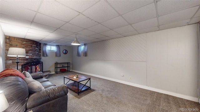 carpeted living room with a paneled ceiling