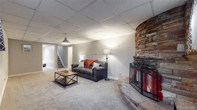 living room featuring carpet flooring and a paneled ceiling