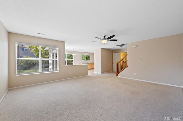 16256 E Otero Pl, Englewood, CO 80112 - unfurnished living room with baseboards, light carpet, ceiling fan, and stairs