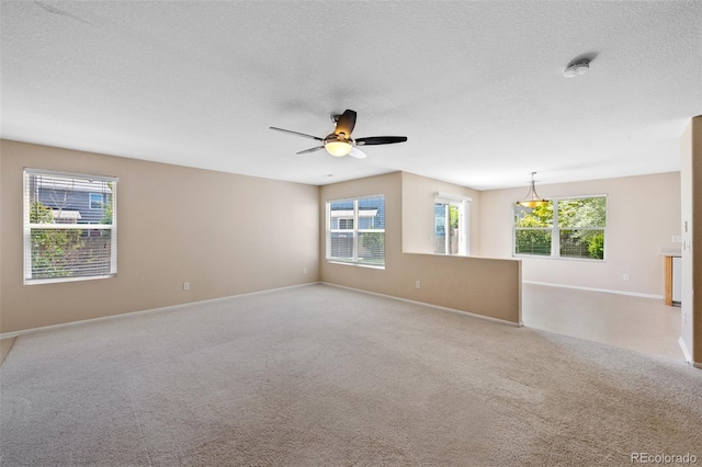 16256 E Otero Pl, Englewood, CO 80112 - unfurnished room with ceiling fan, healthy amount of natural light, baseboards, carpet flooring, and a textured ceiling
