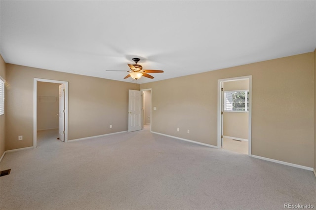 16256 E Otero Pl, Englewood, CO 80112 - unfurnished bedroom featuring a spacious closet, light colored carpet, and baseboards