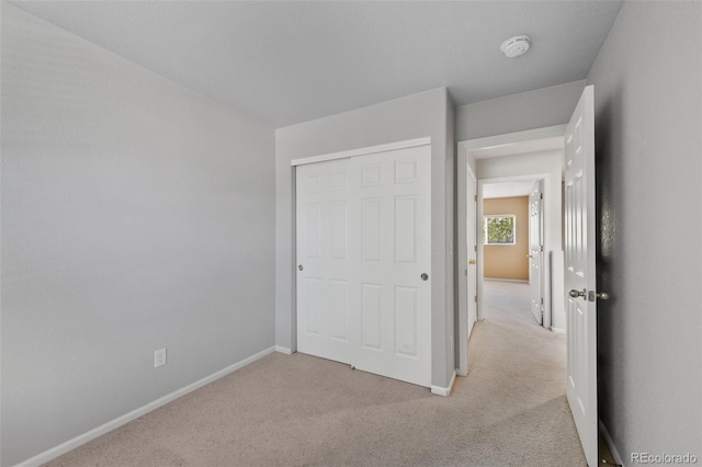 16256 E Otero Pl, Englewood, CO 80112 - unfurnished bedroom featuring light carpet, baseboards, and a closet