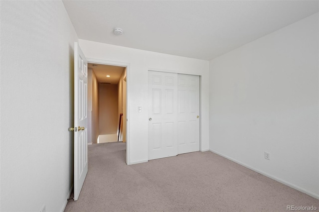 16256 E Otero Pl, Englewood, CO 80112 - unfurnished bedroom with light colored carpet, baseboards, and a closet