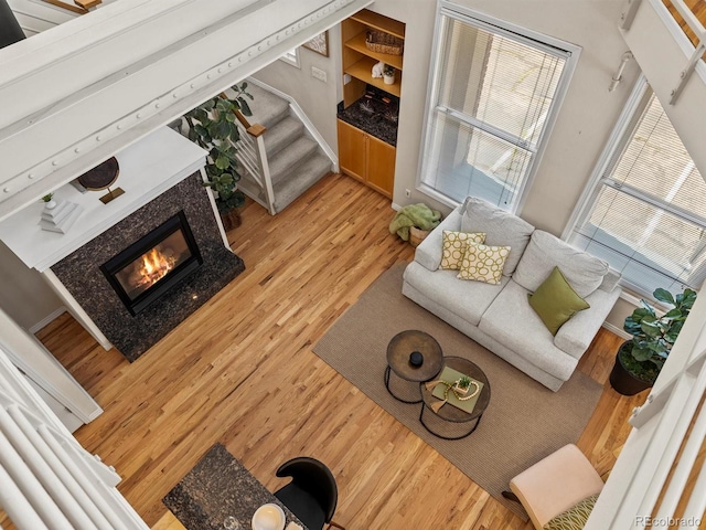 225 N Lincoln St Unit 4, Denver, CO 80203 - living room featuring wood finished floors, stairway, and a tiled fireplace