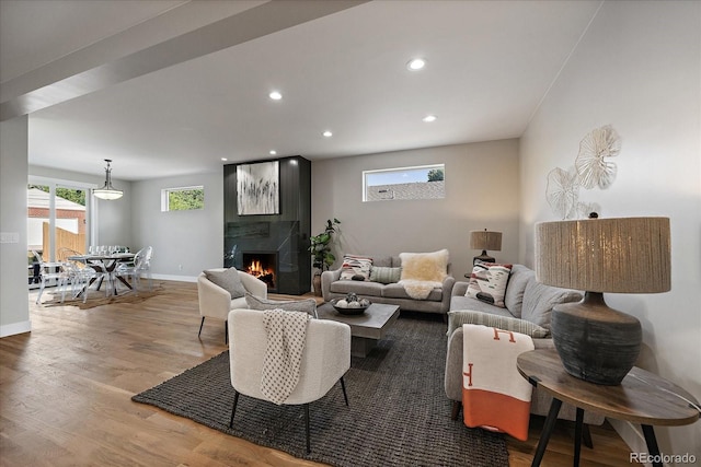 5838 S Louthan St, Littleton, CO 80120 - living room with wood finished floors, recessed lighting, and a lit fireplace