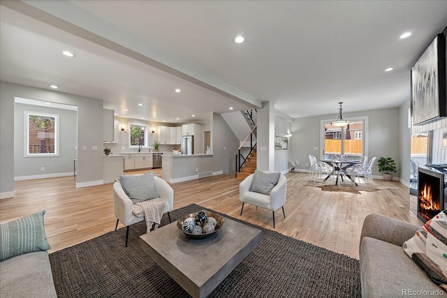 5838 S Louthan St, Littleton, CO 80120 - living room with stairs, light wood-style floors, plenty of natural light, and recessed lighting