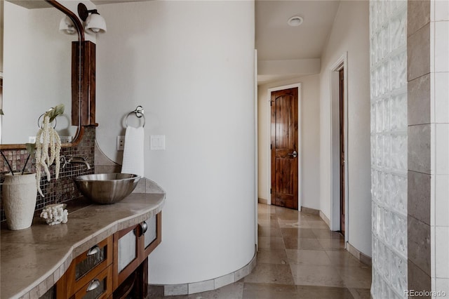 corridor with a sink and baseboards