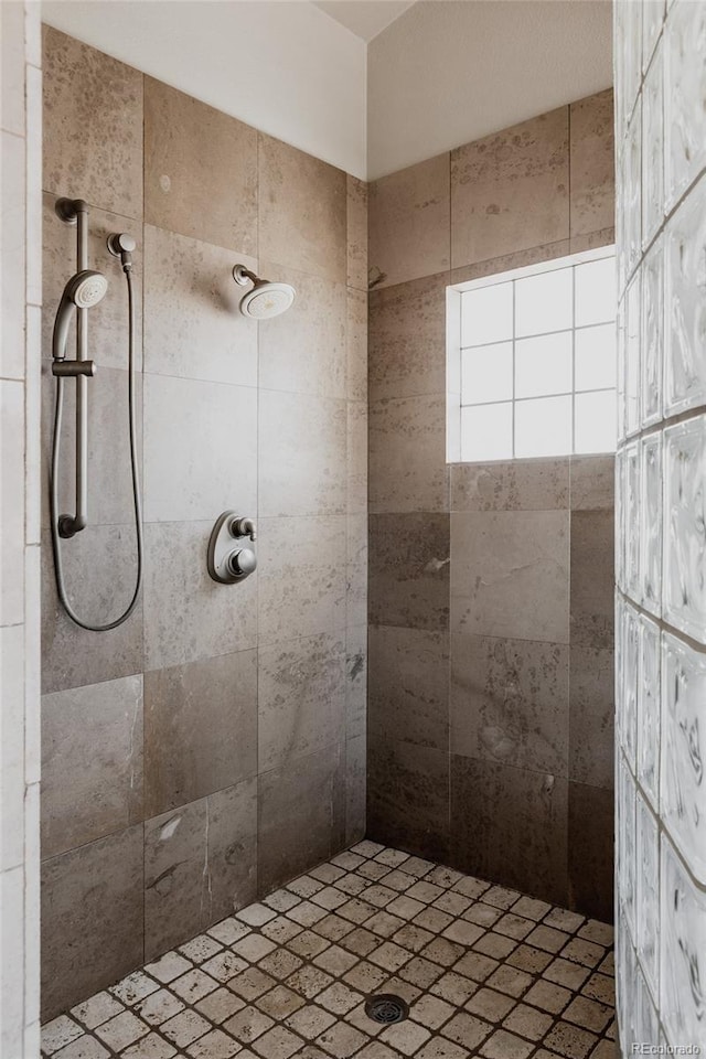 bathroom with a tile shower