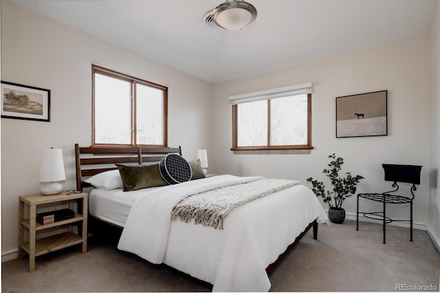 carpeted bedroom featuring baseboards