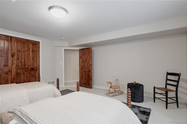 carpeted bedroom featuring baseboards and visible vents