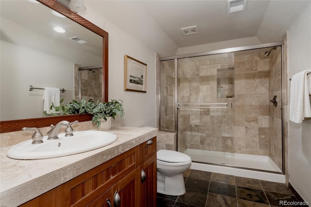 bathroom featuring visible vents, a stall shower, toilet, and vanity