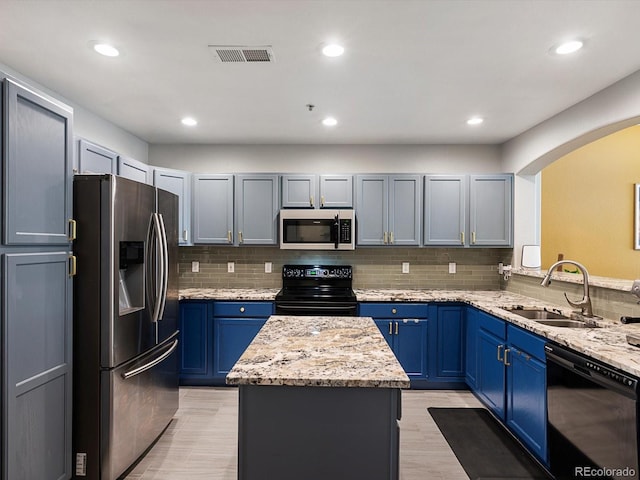 1747 N Pearl St Unit 306, Denver, CO 80203 - kitchen with black appliances, a sink, a center island, arched walkways, and tasteful backsplash