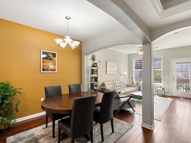 1747 N Pearl St Unit 306, Denver, CO 80203 - dining space with arched walkways, dark wood finished floors, baseboards, ceiling fan, and a chandelier