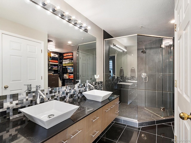 1747 N Pearl St Unit 306, Denver, CO 80203 - full bath with tile patterned floors, a shower stall, double vanity, and decorative backsplash