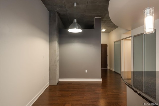 unfurnished dining area with dark wood-type flooring