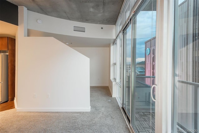 hallway featuring light carpet