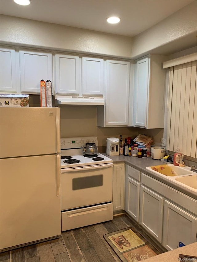 kitchen with white cabinets, white appliances, and sink