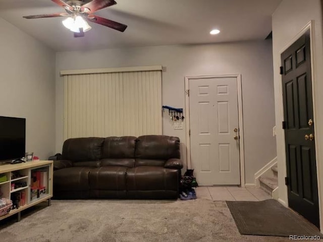 carpeted living room featuring ceiling fan