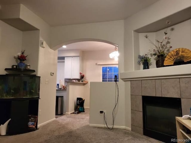 living room featuring light carpet and a fireplace