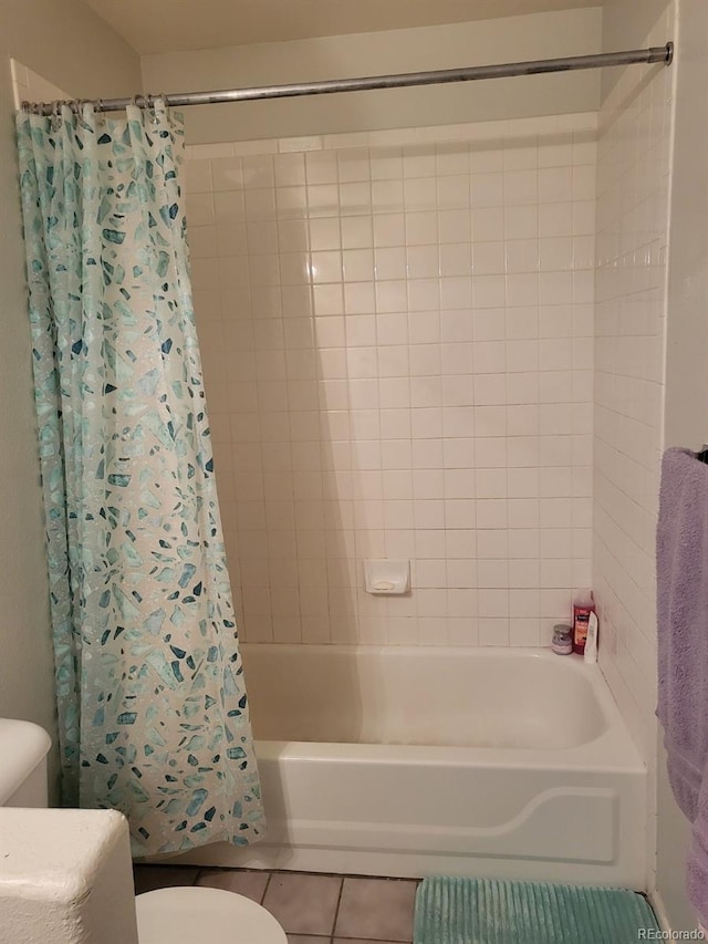 bathroom with tile patterned floors, toilet, and shower / tub combo