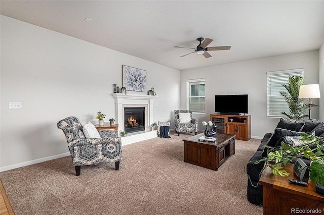 carpeted living room featuring a wealth of natural light and ceiling fan