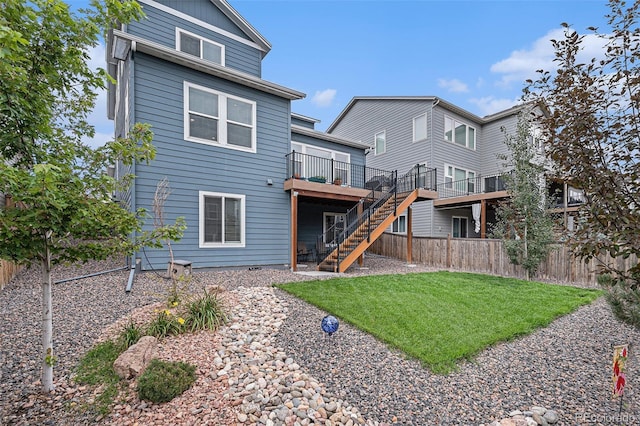 rear view of property with a lawn and a deck