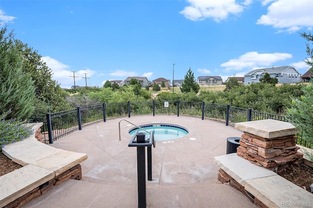 view of swimming pool featuring a community hot tub and a patio