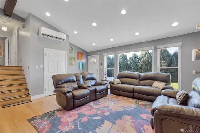 living room featuring an AC wall unit, light hardwood / wood-style flooring, and lofted ceiling