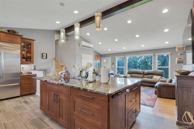 kitchen with pendant lighting, lofted ceiling with beams, stainless steel built in fridge, light stone countertops, and a large island