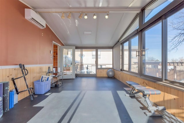 exercise area with an AC wall unit, wooden walls, and track lighting