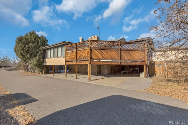 back of house with a wooden deck