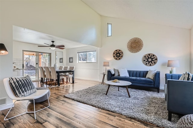 6487 W Weaver Ave, Littleton, CO 80123 - living room featuring high vaulted ceiling, baseboards, wood finished floors, and a ceiling fan