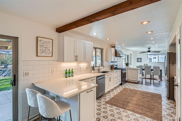 6487 W Weaver Ave, Littleton, CO 80123 - kitchen with appliances with stainless steel finishes, a sink, a peninsula, recessed lighting, and light countertops