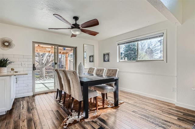 6487 W Weaver Ave, Littleton, CO 80123 - dining area featuring hardwood / wood-style flooring, a ceiling fan, and baseboards