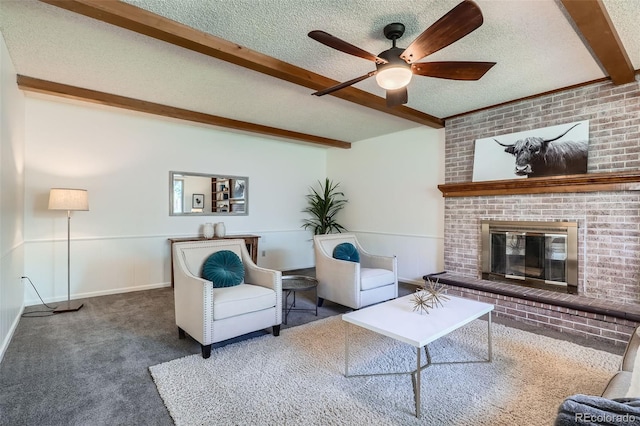 6487 W Weaver Ave, Littleton, CO 80123 - carpeted living area featuring beamed ceiling, a textured ceiling, a ceiling fan, and a brick fireplace