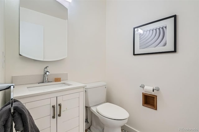 6487 W Weaver Ave, Littleton, CO 80123 - bathroom featuring toilet, vanity, and baseboards
