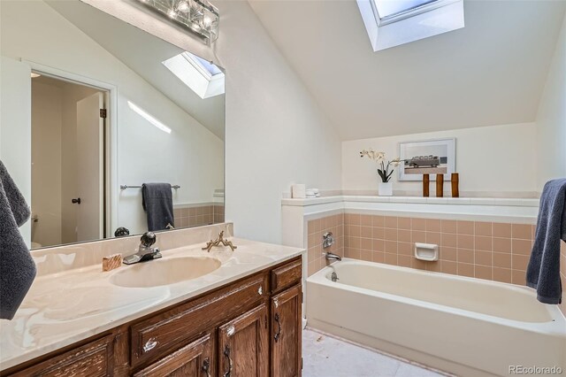 6487 W Weaver Ave, Littleton, CO 80123 - full bath featuring a skylight, vaulted ceiling, a bath, vanity, and tile patterned flooring