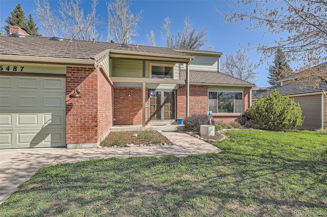 6487 W Weaver Ave, Littleton, CO 80123 - view of front facade featuring brick siding, a front lawn, an attached garage, and concrete driveway