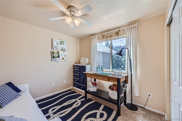 bedroom with light carpet, ceiling fan, a textured ceiling, and baseboards