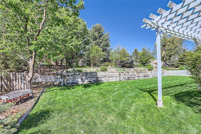 view of yard with fence and a pergola