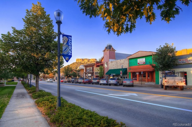 view of street featuring street lighting, curbs, and sidewalks