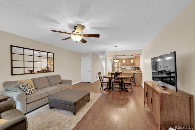 620 Macgregor Ave Unit 11, Estes Park, CO 80517 - living area featuring a ceiling fan, dark wood-style flooring, and a textured ceiling