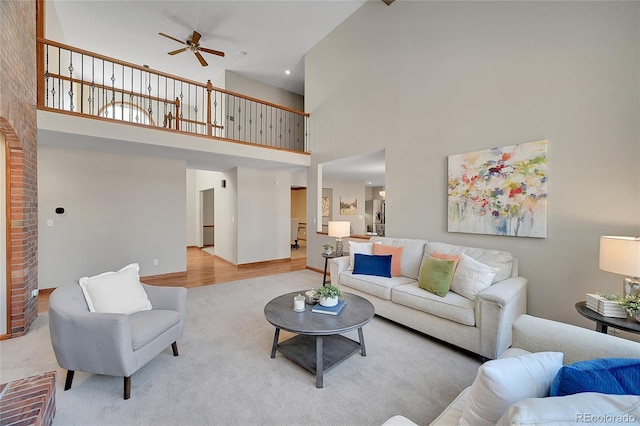 living room with ceiling fan and light carpet